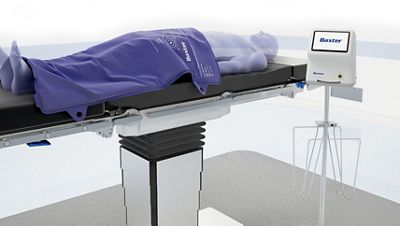A patient uses the Hillrom Patient Warming  System with the PST 500 surgical table