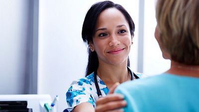 A clinician smiling at her patient.