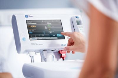 Caregiver using Connex Spot Monitor 