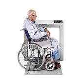 Patient in wheechair on Stow-A-Weigh Wheelchair Scale