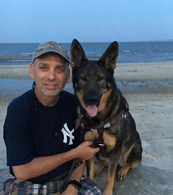 Alan Gunzburg with his dog at the beach.