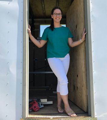 Chelsea Elliott poses in the half Helen mobile clinic.