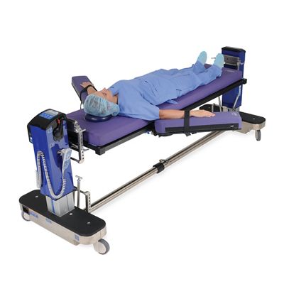 Vue en diagonale de la table Allen Advance avec patient en décubitus dorsal, bras tendus