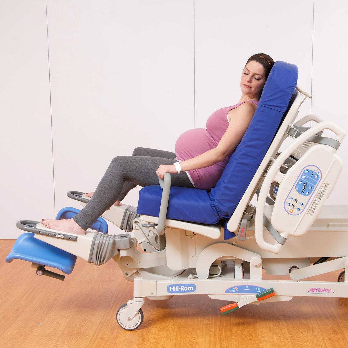 A pregnant woman reclines in an Affinity 4 Birthing Bed in an upright sitting position