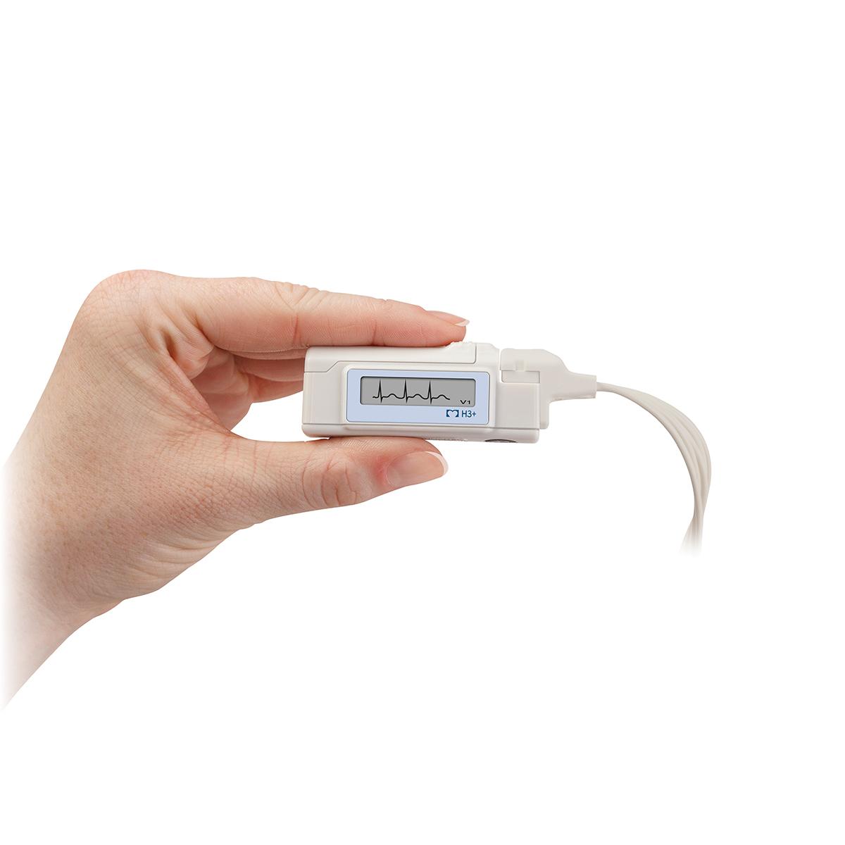 An H3+ Digital Holter Recorder is held between fingers, with waveforms visible on screen