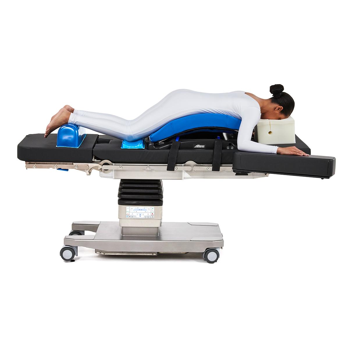 Patient positioned on Hillrom surgical table equipped with Prone Bow Frame accessories.