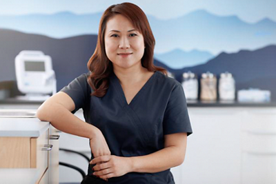 nurse portrait at a nurse station with Welch Allyn Spot Vital Signs 4400 Device in the backgroun