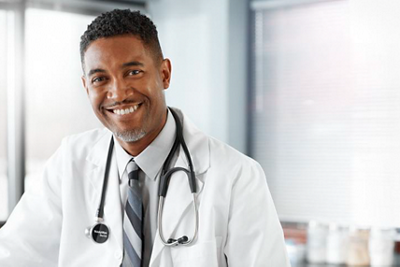 doctor head shot smiling in doctor's office