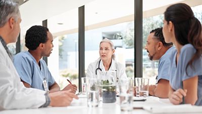 Group of healthcare professional discussing Voalte reporting and analytics