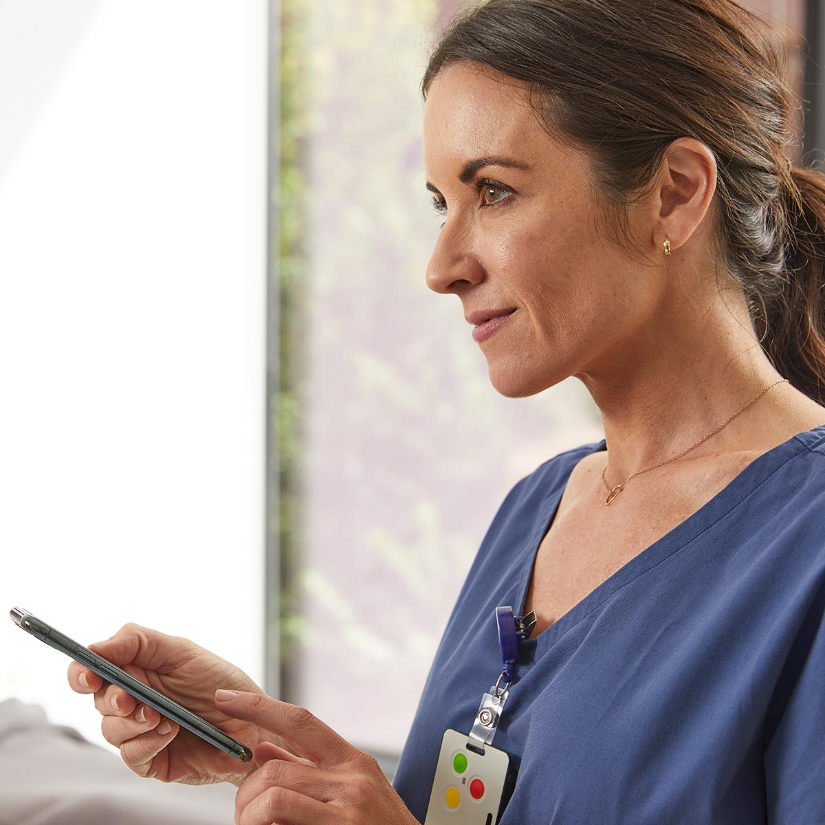 Nurse using the Voalte Mobile app on her iPhone