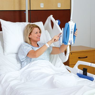 Smiling female patient uses the communication console on the Centrella® Smart+ Bed