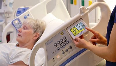 A clinician reviews a patient’s heart and respiratory rates on the Hillrom Centrella Smart+ Bed