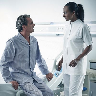 A patient exits the Centuris bed with a caregiver nearby