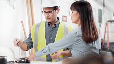 Construction planners or architects review plans for a hospital construction project
