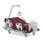 Excel Care ES Bariatric Hospital Bed, 3/4 view, head of bed raised with trapeze