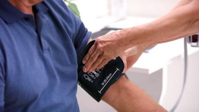 A clinician takes a patient’s blood pressure using a Welch Allyn Spot Vital Signs 4400 Device  
