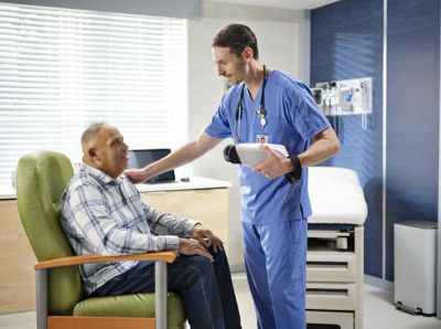 physician holding retinavue with patient