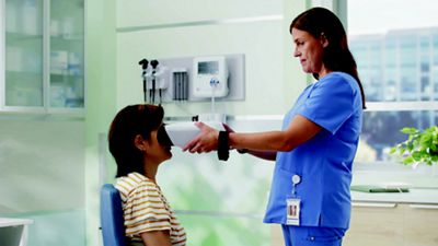 Woman sitting with Nurse holding Retinavue 700