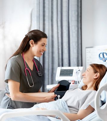 A clinician takes a patient's blood pressure.