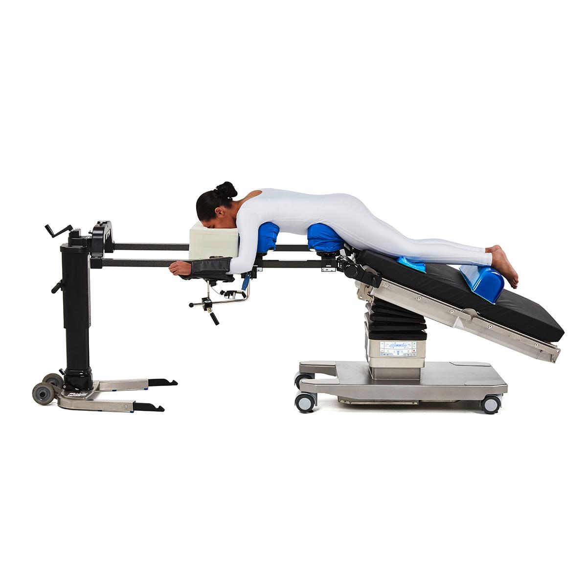 Patient in the prone position on Hillrom surgical table equipped with Universal Spine Frame accessories.