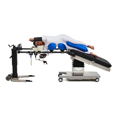 Patient in the lateral position on Hillrom surgical table equipped with Universal Spine Frame accessories.