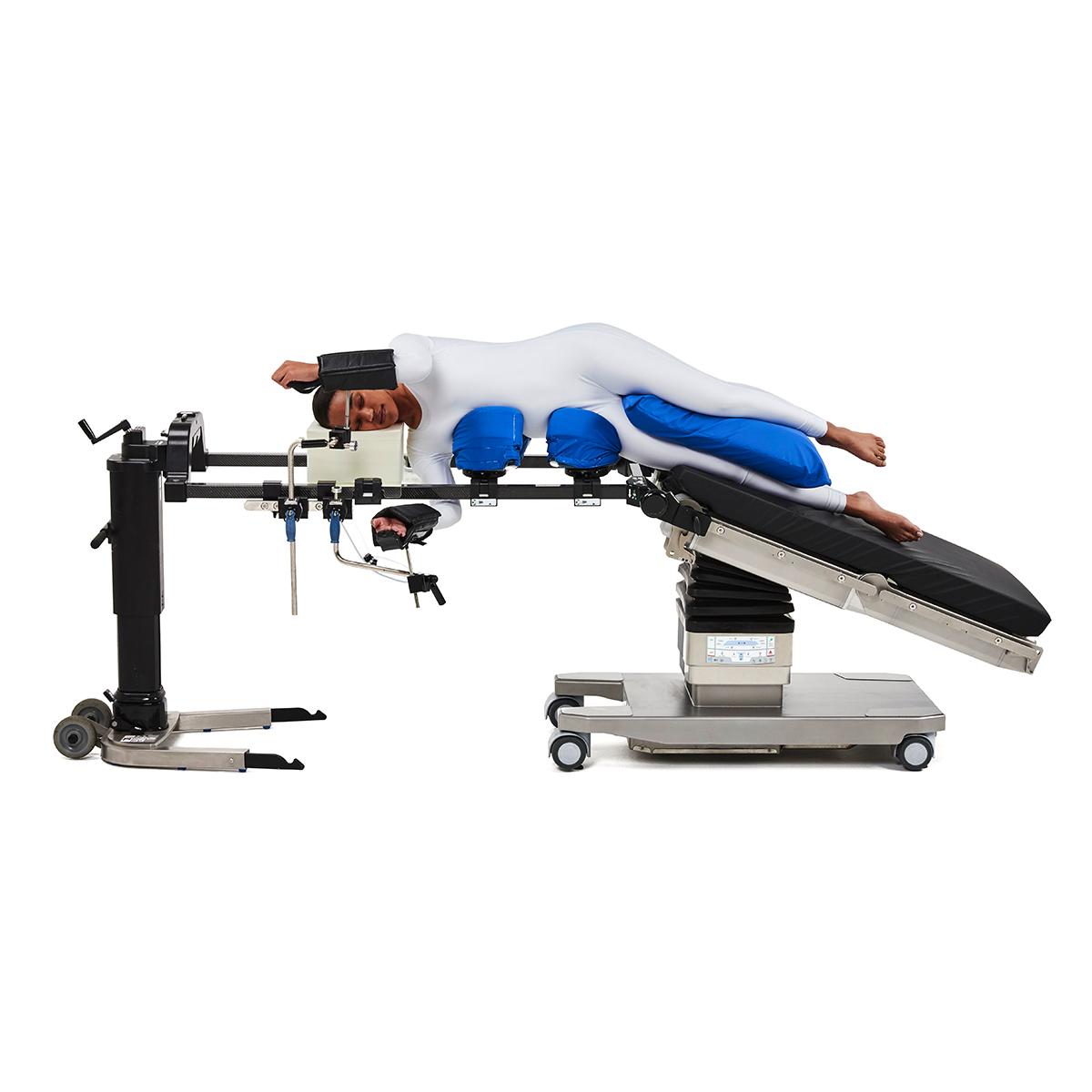Patient in the lateral position on Hillrom surgical table equipped with Universal Spine Frame accessories.