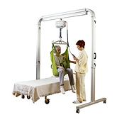 A clinician helps move a patient in a seated position using a FreeSpan straight rail lift system