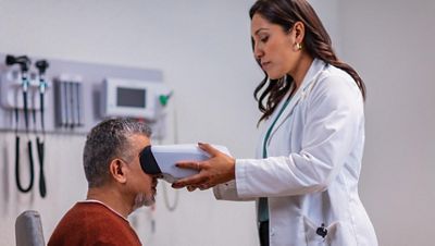 Patient receiving diabetic retinal exam