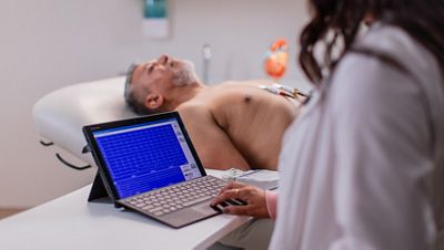 A physician performs a resting ECG exam using the Diagnostic Cardiology Suite ECG
