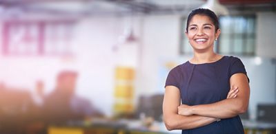 A professional woman smiles in a modern office environment