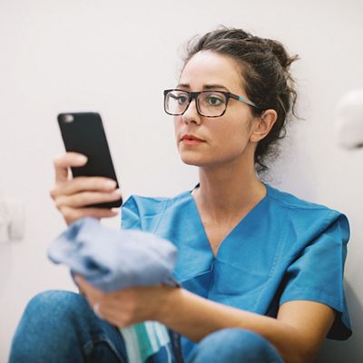 Caregiver with smartphone using mobile app