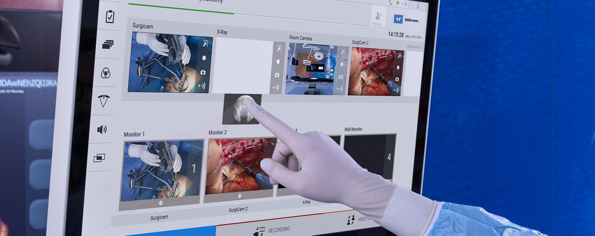 Gloved clinician uses the Helion system’s drag-and-drop functionality
