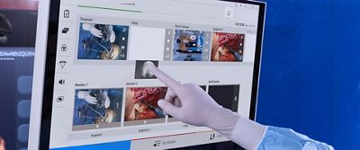 Gloved clinician uses the Helion system’s drag-and-drop functionality