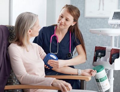  A clinician places his hand on a patient’s shoulder while talking in a primary care office. 