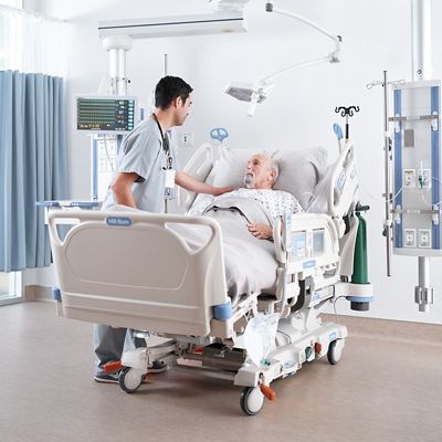 Patient in the ICU being comforted by his clinician
