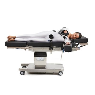 Patient in lateral position on surgical table being supported by siderail mounted braces.