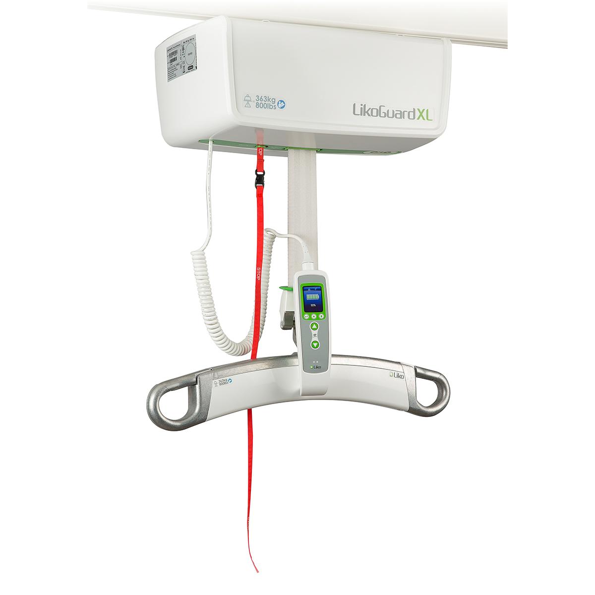 A posterior view of the rail-based LikoGuard XL overhead patient lift. A red emergency override button is at the unit's top left.