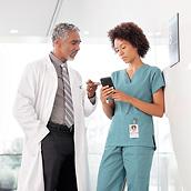Nurse using Voalte Mobile app while talking with physician