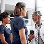 Nurses reviewing patient information on Voalte Mobile app