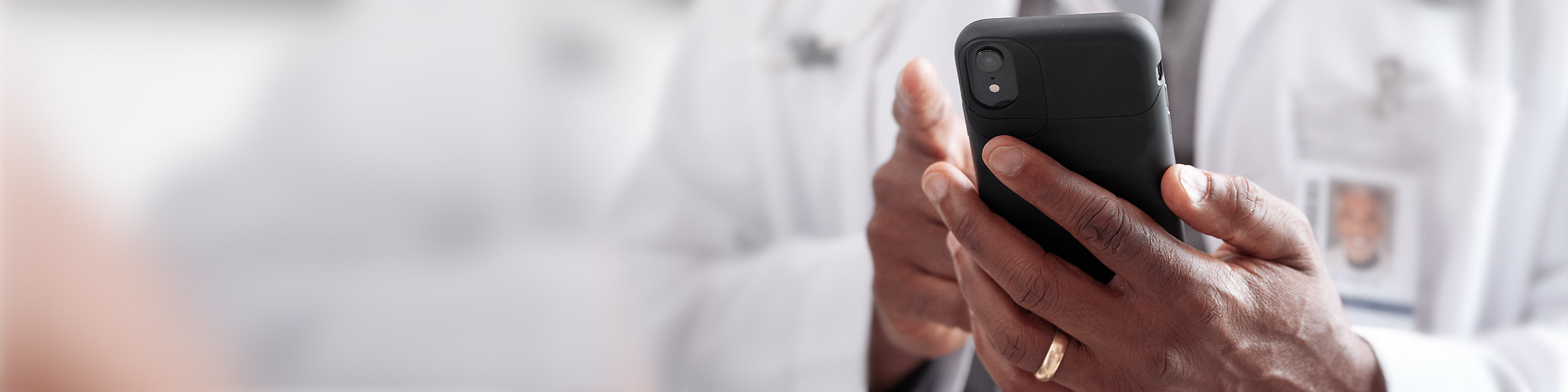 A medical professional reviewing contact information on a smartphone device