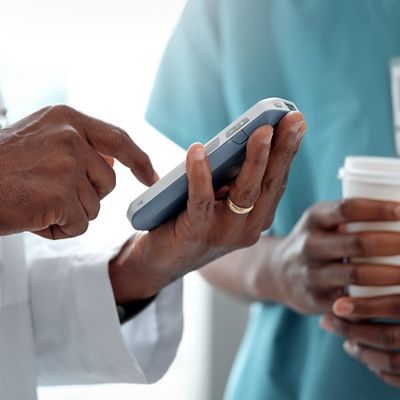 care team, physician holding smartphone, caregiver holding coffee cup