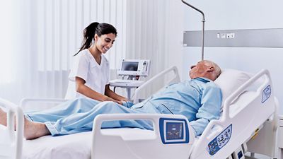 Team of surgeons operating in robotic operating room 