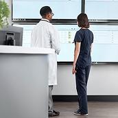 Nurse and physician looking at real-time patient information on the Voalte® Status board