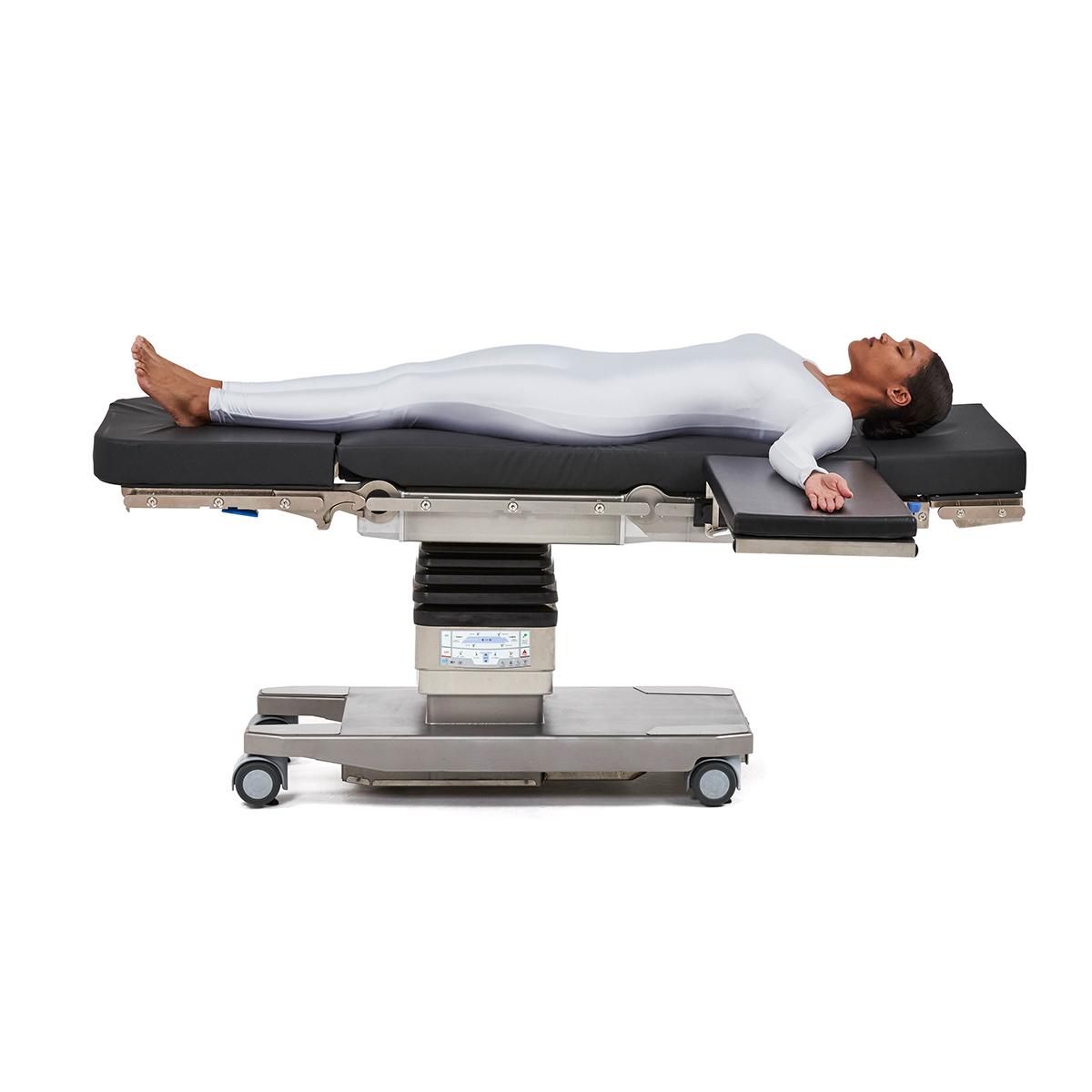 Patient positioned on Hillrom surgical table equipped with Arm and Hand OR accessories.