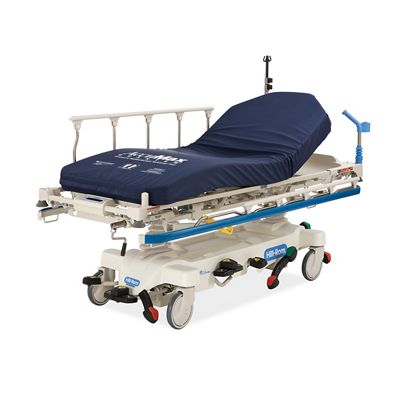 Hillrom Procedural Stretcher, diagonal view with AccuMax Quantum™ surface and blue bumper.