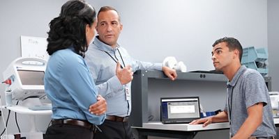 A team of biomedical engineers use Hillrom’s remote service management tool to discuss their maintenance priorities and plan for the week ahead. 