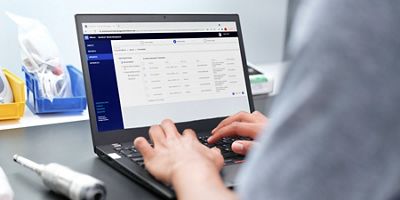 A biomedical engineer uses a remote device management tool to select multiple devices that need an update for faster update deployment. 