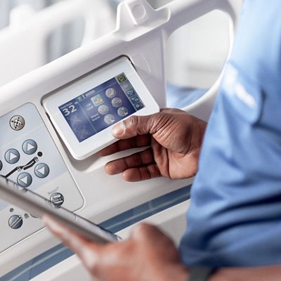 A Hillrom representative tests a Centrella Smart+ Bed for proper function