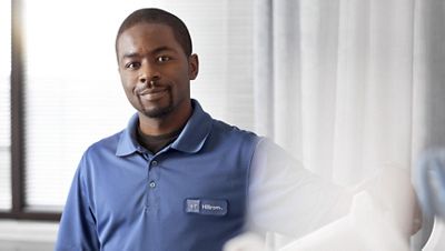 A Hillrom service technician is on-site at an urgent care facility or retail clinic to set up new devices.