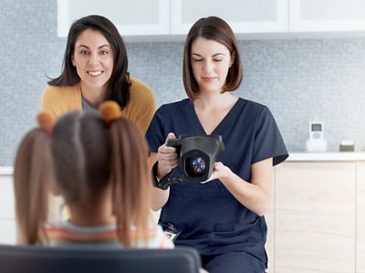 School-age girl looking getting vision screening
